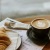 coffee and a crescent on a table in front of a window